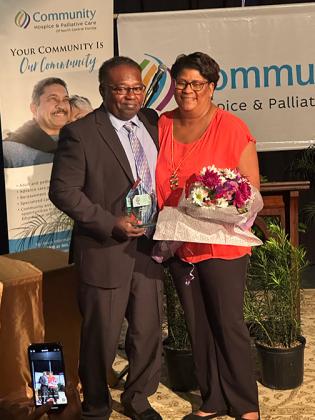 Courtesy of Community Hospice & Palliative Care of North Central Florida. Bryant Oxendine smiles for a photo with his wife, Titania Oxendine, after receiving the Community Servant's Hummingbird Award earlier this month. 