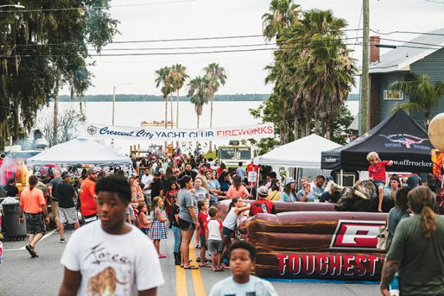 Crescent City residents and visitors walk on the street Saturday during Red, White & Boom, which kicked off a string of Independence Day events in Putnam County. 
