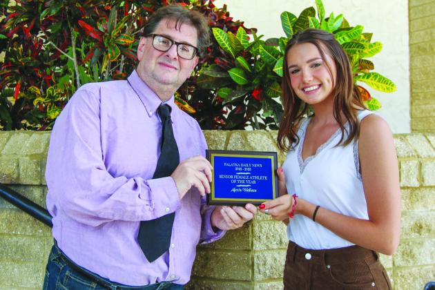 Peniel Baptist Academy two-sport star Alexis Wallace shows off her Senior Female Athlete of the Year plaque with Palatka Daily News sports editor Mark Blumenthal. (SARAH CAVACINI / Palatka Daily News)