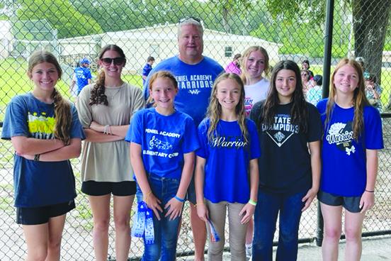 Peniel Baptist Academy softball coach Jeff Hutchins poses with players who helped he and the Warriors earn their fourth straight district and fifth Florida Christian Athletic League titles. From left are Allie Peacock, Alexis Wallace, McKenzie Zurn, Reagan Guthrie, Lexi Peacock, Kylen Andrews and Aaliyah Hall. (MARK BLUMENTHAL / Palatka Daily News)