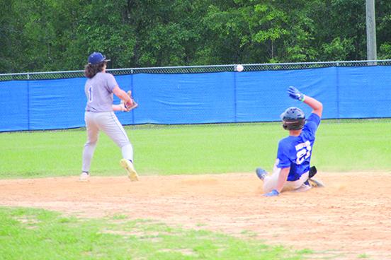 Melrose 15-and-under baseball player Tyler Brinson slides safely into second during their scrimmage with Melrose 13-U all-star team as second baseman Ashton Norris field the ball Wednesday. (COREY DAVIS / Palatka Daily News)