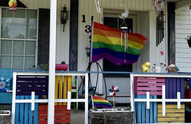 A pride flag flies outside the Satsuma home of Judi and Marla Kosmar-Woods.