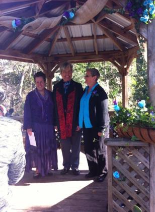 Marla Kosmar-Woods (left) stands on Jan. 10, 2015, with her wife Judi Kosmar-Woods and Rev. Donna Cooney on the couple's wedding day at Ravine Gardens State Park.  