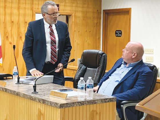 Photo by AL KROMBACH / Charles Rudd, left, city manager of Crescent City, chats with City Attorney George Young following Thursday’s City Commission meeting.