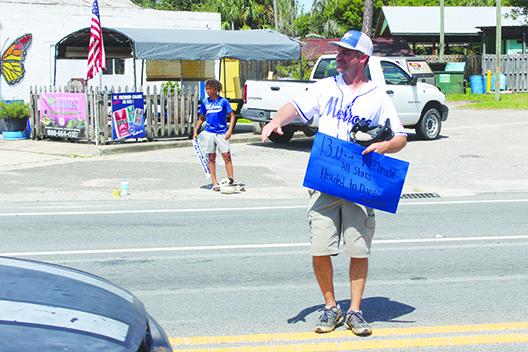 Melrose Babe Ruth 13-and-under all-star baseball coach Mark Musgrove looks for donations for his team on Saturday. (MARK BLUMENTHAL / Palatka Daily News)