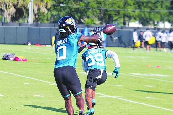 New Jaguars receiver Calvin Ridley hauls in a pass during Wednesday’s opening practice of the season with teammate Ray Agnew blocking in front of him. (MARK BLUMENTHAL / Palatka Daily News)