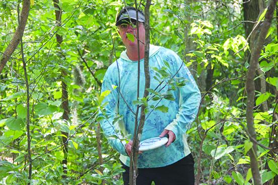 Bobby Lyle from Crown Point, Indiana plays a round of disc golf at Hallie’s Landing in Crescent City. (COREY DAVIS / Palatka Daily News)