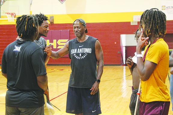 Crescent City Junior-Senior High School boys basketball coach Al Carter (center) talks with his players during a recent practice. (COREY DAVIS / Palatka Daily News)