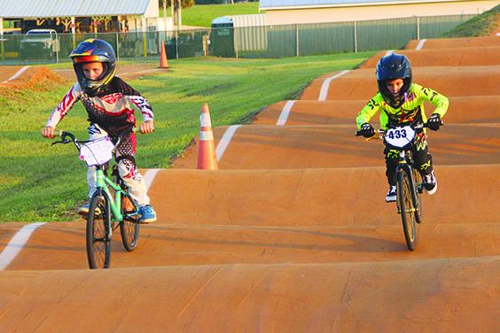 Two unidentified riders battle it out during a recent BMX practice session at Ancient City BMX in Elkton. (COREY DAVIS / Palatka Daily News)