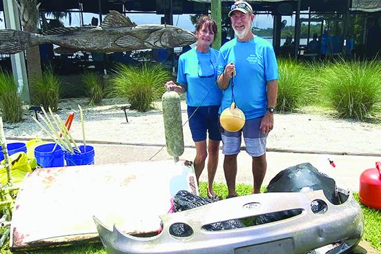 Clean up Florida Waterways volunteers Kathy and Frank Streeter of East Palatka found big items along the St. Johns River shores to add to the hundreds brought to Crystal Cove Marina, including an automobile bumper, a refrigerator door and dozens of floating items. (Becky Williams / Submitted)