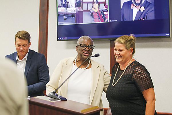 SARAH CAVACINI/Palatka Daily News -- Outgoing Palatka City Attorney Valeria Thomas, left, congratulates incoming City Attorney Jane West, right, before West gets sworn in during a City Commission meeting Thursday evening.