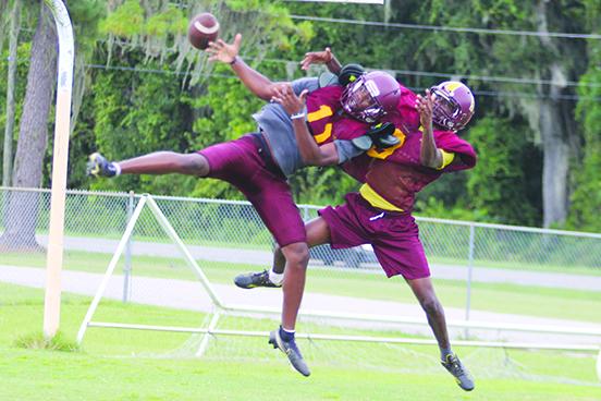 Crescent City's Arzavian Williams (right) knocks the ball away from receiver Freddy Major during a pass play in Thursday's practice. (MARK BLUMENTHAL / Palatka Daily News)
