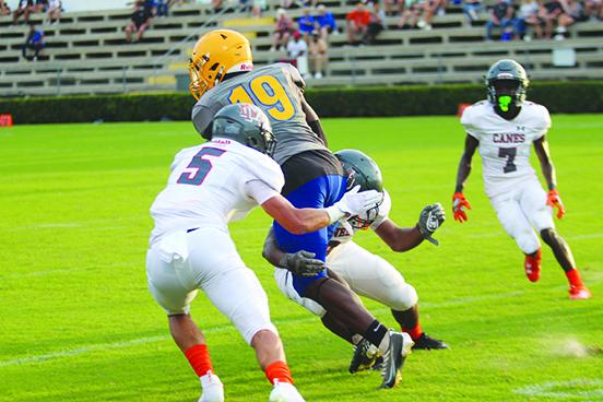 Palatka’s Trenton Williams (19) takes on a pair of would-be Mount Dora tacklers on last Friday night in the preseason game. Williams picked up nine yards on the reception. (MARK BLUMENTHAL / Palatka Daily News)