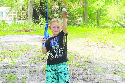 Five-year-old Bostwick resident Zamman Kinlaw shows off a fish he caught during an outing with his brother in Bostwick. (COREY DAVIS / Palatka Daily News)