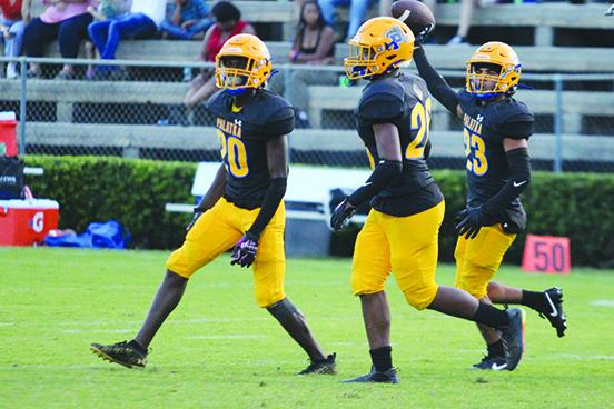 Palatka’s Robert Walker (right) holds the football up after recovering a first-quarter fumble against Belleview Friday night. (MARK BLUMENTHAL / Palatka Daily News)