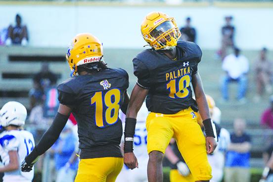 Palatka's George Taylor (18) and Tommy Offord celebrate Offord’s 2-yard scoring run in the second quarter. (MARK BLUMENTHAL / Palatka Daily News)