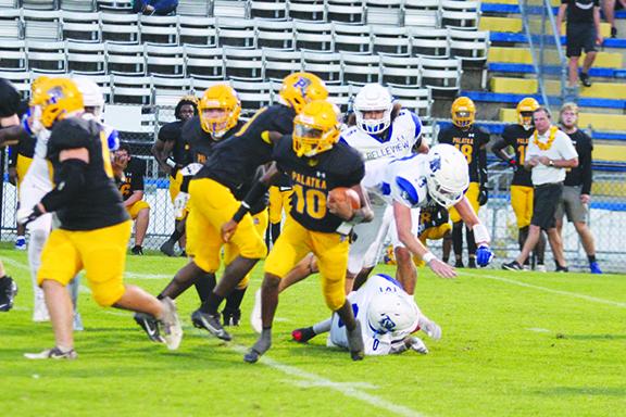 Palatka Junior-Senior High quarterback Tommy Offord navigates his way through Belleview’s defense during the Panthers’ 35-8 win Sept. 15. (MARK BLUMENTHAL / Palatka Daily News)