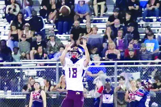 Crescent City’s Andrew Roosa goes high to make one of his two catches Friday night. (RITA FULLERTON / Special to the Daily News)