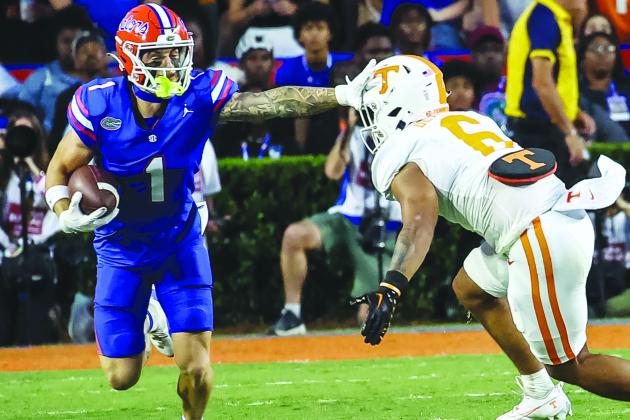 Florida’s Ricky Pearsall tries to push away Tennessee defender Aaron Beasley after a reception. (JOHN STUDWELL / Palatka Daily News)