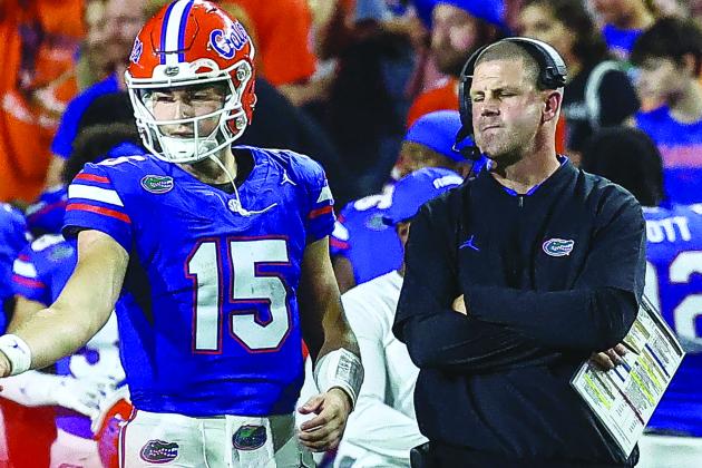 Florida Gators quarterback Graham Mertz talks with head coach Billy Napier during a timeout in Saturday night’s game against Charlotte at Ben Hill Griffin Stadium. (JOHN STUDWELL / Special to the Daily News)