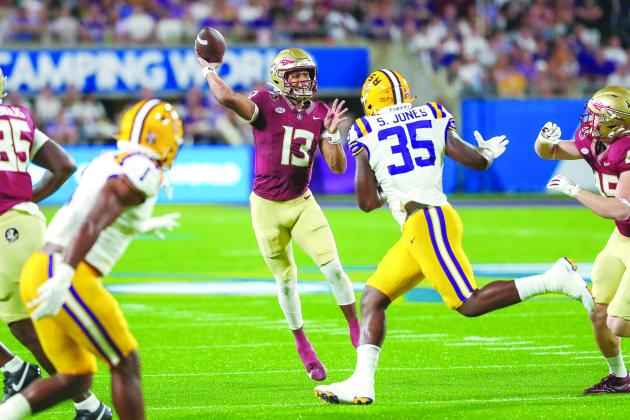 Florida State’s Jordan Travis attempts a pass against LSU’s Sai’vian Jones. (GREG OYSTER / Special to the Daily News)