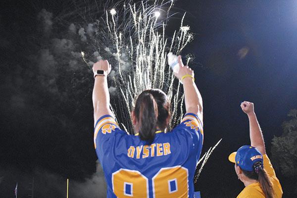 BRANDON D. OLIVER/Palatka Daily News – Palatka Junior-Senior High School Principal Cathy Oyster celebrates at the Panther Prowl on Thursday as fireworks explode in the sky.