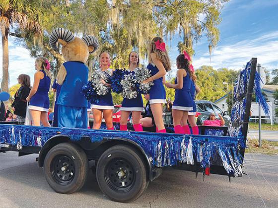 Submitted photo – Interlachen Junior-Senior High School varsity cheerleaders ride on a float during the school’s Homecoming Parade on Thursday.