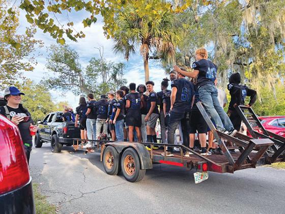 Submitted photo – Varsity football players greet the crowd at the school’s Homecoming Parade on Thursday evening. 