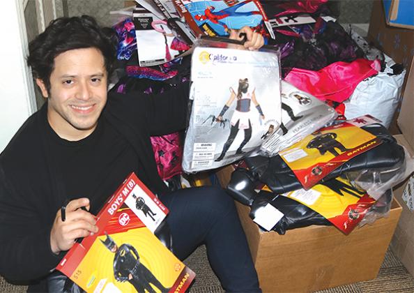 TRISHA MURPHY/Palatka Daily New – Jonathan Garcia holds some of the costumes he plans to give away Saturday, continuing an annual tradition of making sure local kids can dress up for Halloween.