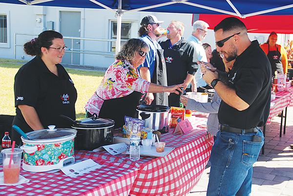 File photo – People serve and taste chili during a Ten-24 Foundatiion fundraiser in 2022. This year, the fundraiser will be a barbecue cookoff.