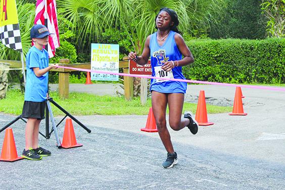 Palatka’s Ymira Passmore crosses the finish line to win her fourth consecutive All-Putnam County cross country championship Tuesday at Ravine Gardens State Park, the first girl to win four titles. (MARK BLUMENTHAL / Palatka Daily News)