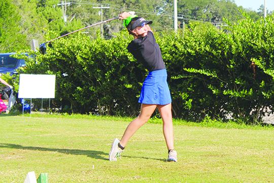 Palatka’s Tatum Wilhite watches the flight of her first tee drive during Monday’s District 4-2A girls golf tournament at the Palatka Municipal Golf Club. (MARK BLUMENTHAL / Palatka Daily News)