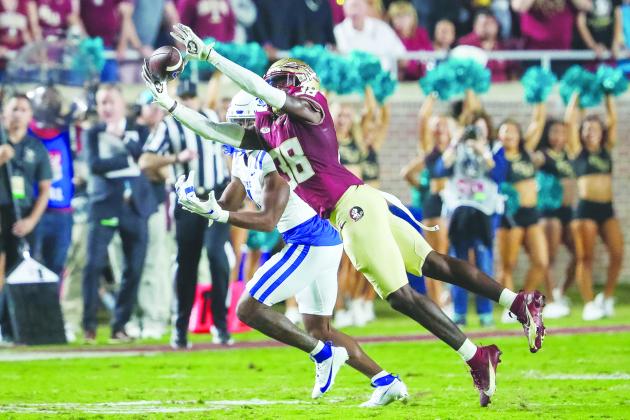 Florida State’s Shyheim Brown jumps in front of Duke’s Jontavis Robertson for an interception in Saturday’s victory in Tallahassee. (GREG OYSTER / Special to the Daily News)