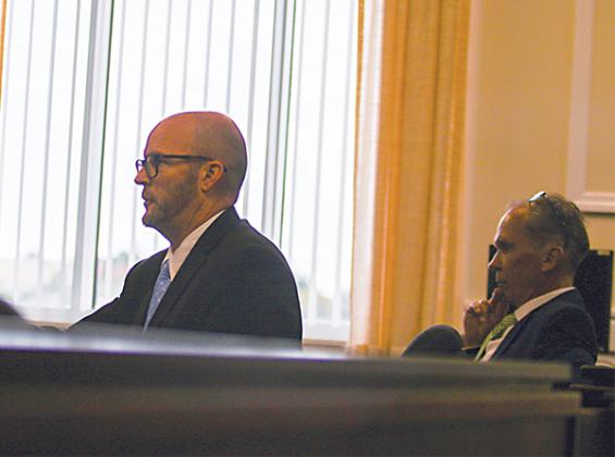 File photo – Craig Oates, right, and his attorney, Richard Mockler, attend legal proceedings in August in hopes of removing Crescent City Commissioner Cynthia Burton from office.