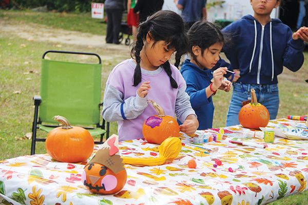 SARAH CAVACINI/Palatka Daily News – Mia and Maylene Ruiz paint pumpkins Saturday during the inaugural Interlachen Fall Festival.