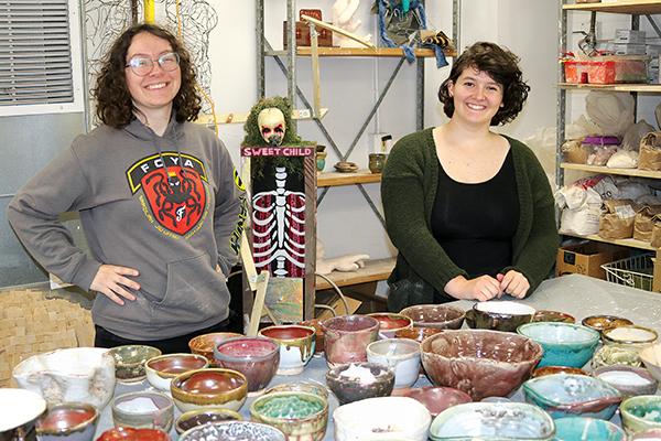 TRISHA MURPHY/Palatka Daily News - Florida School of the Arts students Carol Stephenson, left, and Brynn Lacouture hold the bowls they made that will be used in the Empty Bowls fundraiser next week.