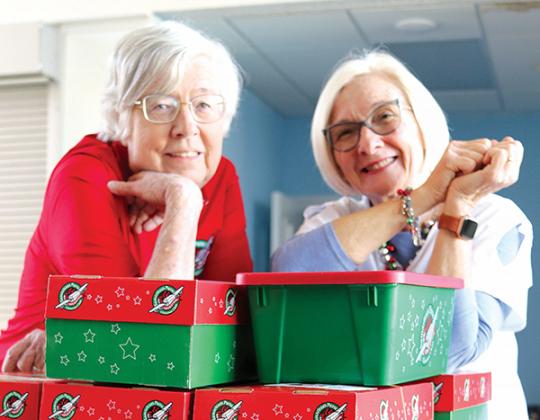 TRISHA MURPHY/Palatka Daily News – Elaine Clark, left, and Cynthia Adams are pictured with shoeboxes filled with toys and other items First Baptist Church of Palatka members have donated for Samaritan’s Purse Operation Christmas Child.