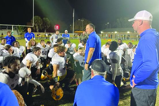 Palatka Junior-Senior High football coach Patrick Turner (middle) addresses his team after a 28-27 loss to Gainesville Eastside on Friday at Citizens Field. (MARK BLUMENTHAL / Palatka Daily News)