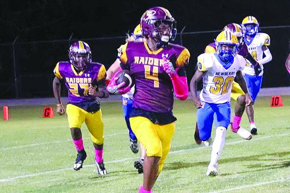 Crescent City’s Lentavious Keenon goes for yardage after a catch against Newberry. (RITA FULLERTON / Special to the Daily News)