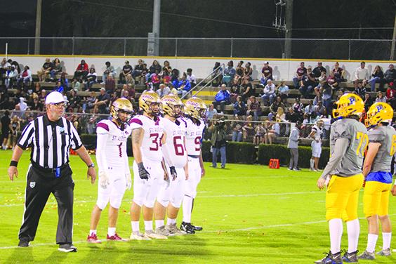 St. Augustine and Palatka players line up after the coin toss before the 2022 game at Bennett-Cooper Field at Veterans Memorial Stadium. (MARK BLUMENTHAL / Palatka Daily News)
