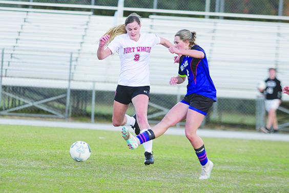 Interlachen’s Madi Guessford (right) kicks the ball away from Fort White’s Jaylynn Wilkinson during the first half. (MARK BLUMENTHAL / Palatka Daily News)