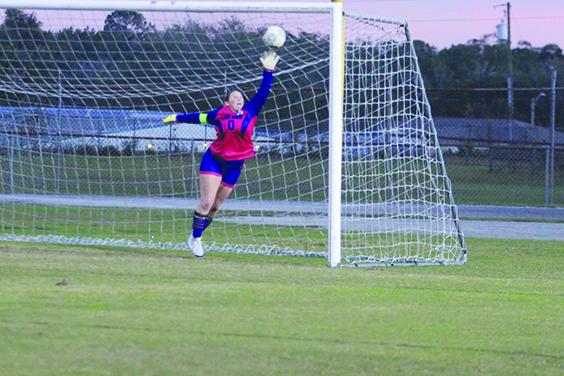 Interlachen girls soccer goalie Paige McCollum goes high for a Marlee Hunt shot in the first half Wednesday night, but the ball goes past her for Fort White’s second goal of the game. (MARK BLUMENTHAL / Palatka Daily News)