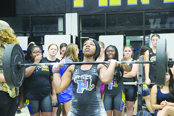 Palatka weightlifter Al’Lyssa Ford, seen here during the clean and jerk, won titles in her 169-pound class in Olympic and traditional competitions at Friday’s Feast Mode event at Palatka Junior-Senior High School. (COREY DAVIS / Palatka Daily News)