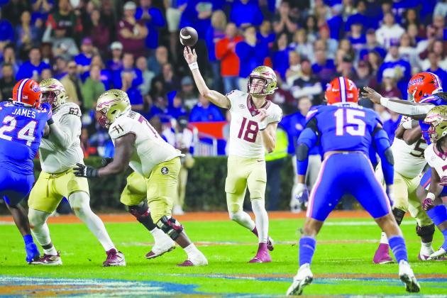 Florida State quarterback Tate Rodemaker is protected in the pocket as he launches a pass during the Seminoles’ 24-15 victory over Florida Saturday night at Ben Hill Griffin Stadium. (GREG OYSTER / Special to the Daily News)