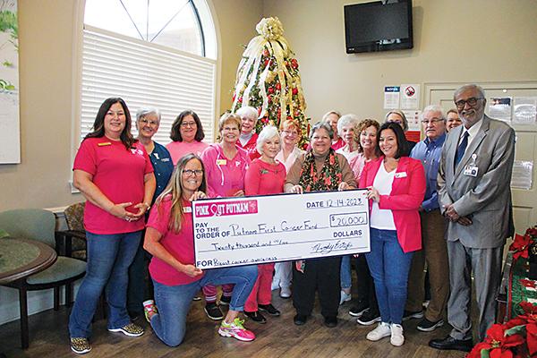 SARAH CAVACINI/Palatka Daily News – Pink Out Putnam members hand over a $20,000 check to the Putnam First Cancer Fund last week.