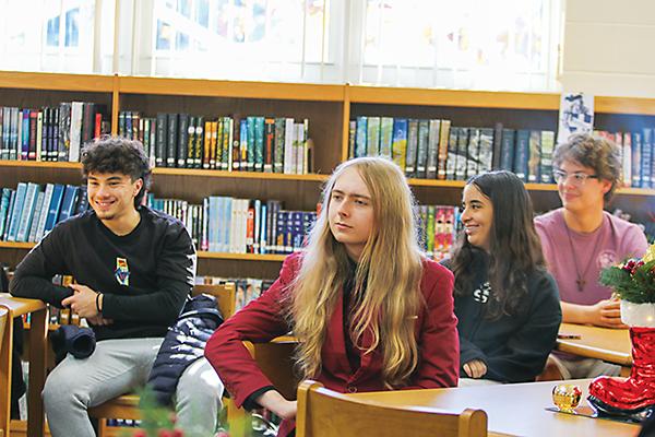 SARAH CAVACINI/Palatka Daily News - Q.I. Roberts Junior-Senior High School students Noah Lotow, Gavin Miles, Leah Zabad and Matthew Snider talk about the Cambridge program with school district and state officials.