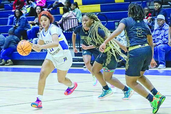 Palatka’s Charnelle Cue (11) is pursued by Oakleaf defenders Makayla Trusel (center) and Makiya Trusel (2) during Friday night’s Jarvis Williams Holiday Classic basketball game. (RITA FULLERTON / Special to the Daily News)