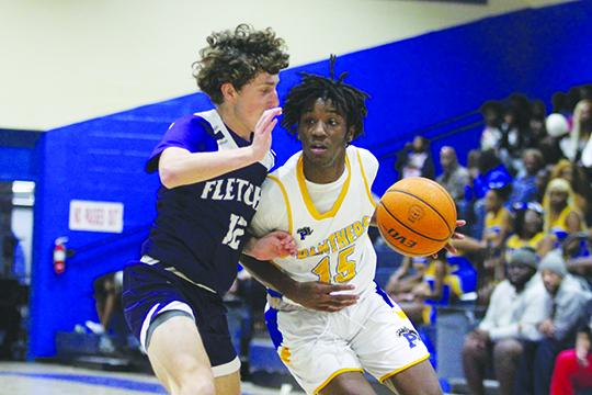 Palatka’s Dequan Jackson looks to move while guarded by Neptune Beach Fletcher’s Sam Perry during Wednesday’s game in the Jarvis Williams Holiday Classic. (MARK BLUMENTHAL / Palatka Daily News)