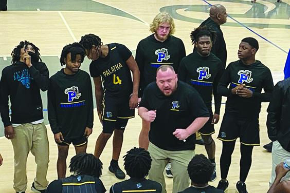 Palatka Junior-Senior High School boys basketball coach Bryan Walter does his best to fire up his team during a second-quarter timeout. (COREY DAVIS / Palatka Daily News)