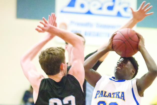 Palatka’s Anfernee Royster puts a shot up against Ponte Vedra’s Ross McCarthy during the first half of Palatka’s 62-51 district regular-season victory on Jan. 10, 2015, at Palatka. (Daily News file photo)